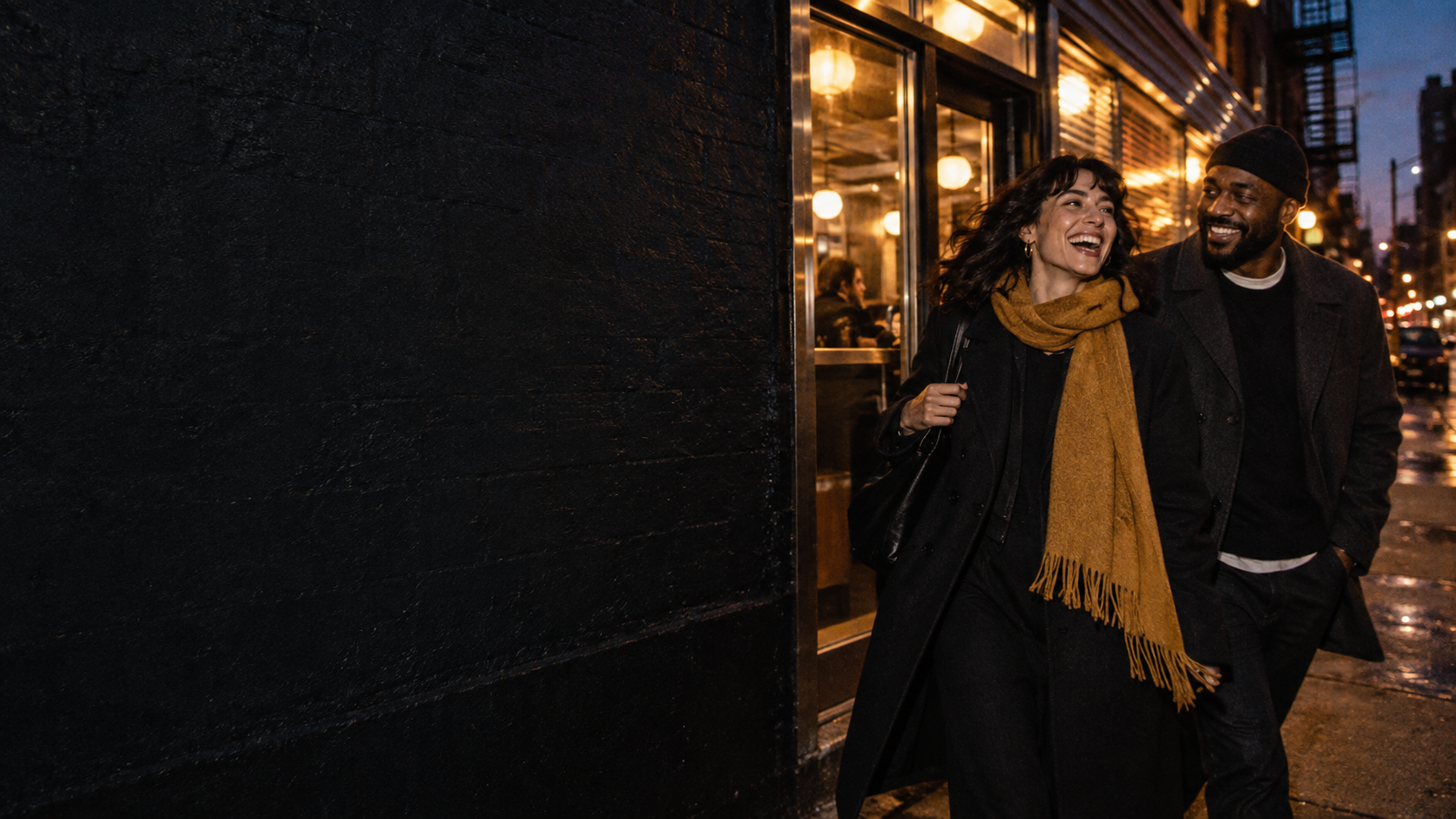 Two friends walking together along a warmly lit city street